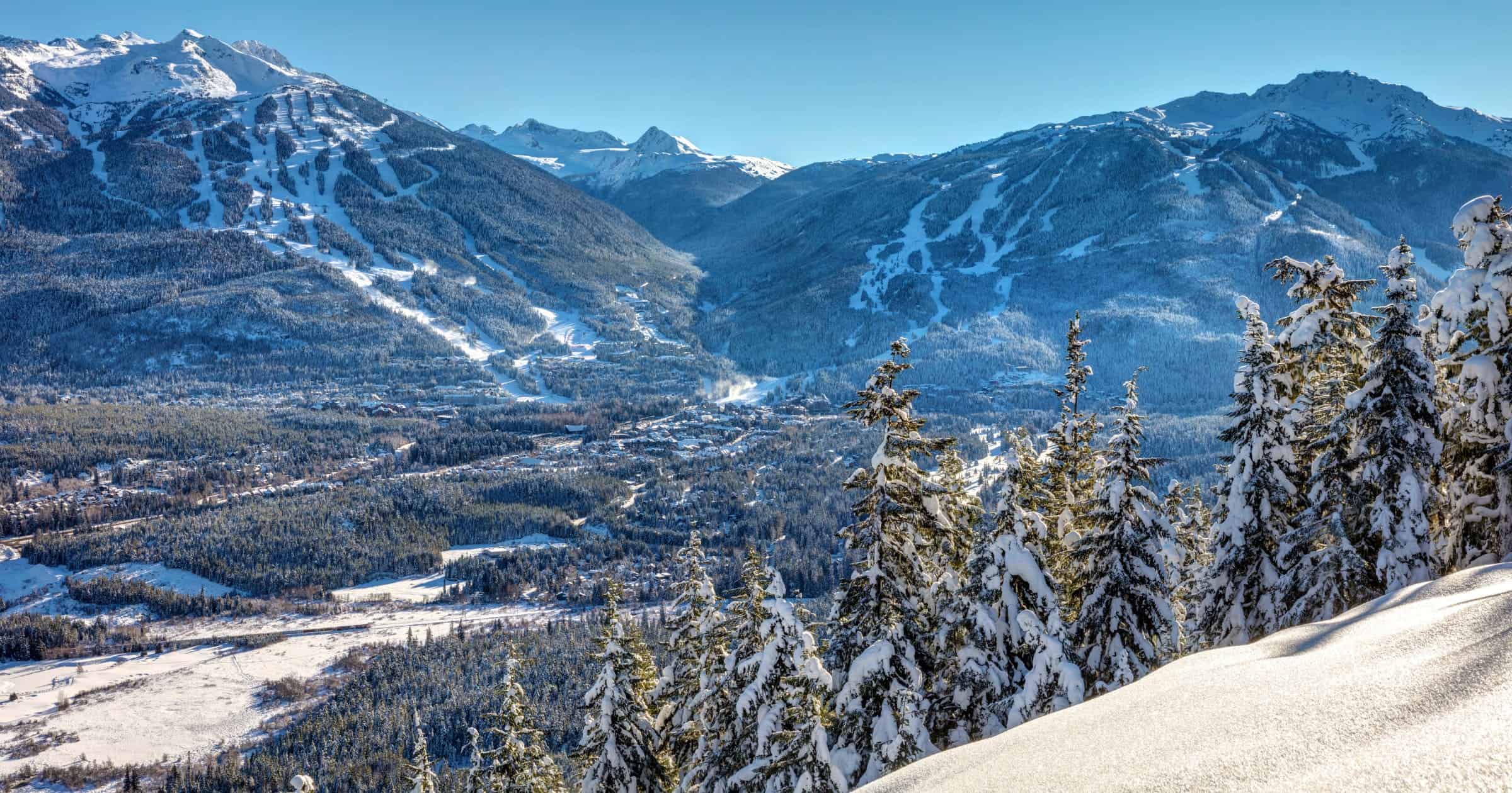 Whistler Blackcomb Mountains in Winter after a fresh snowfall on a sunny blue sky day. British Columbia, Canada 

