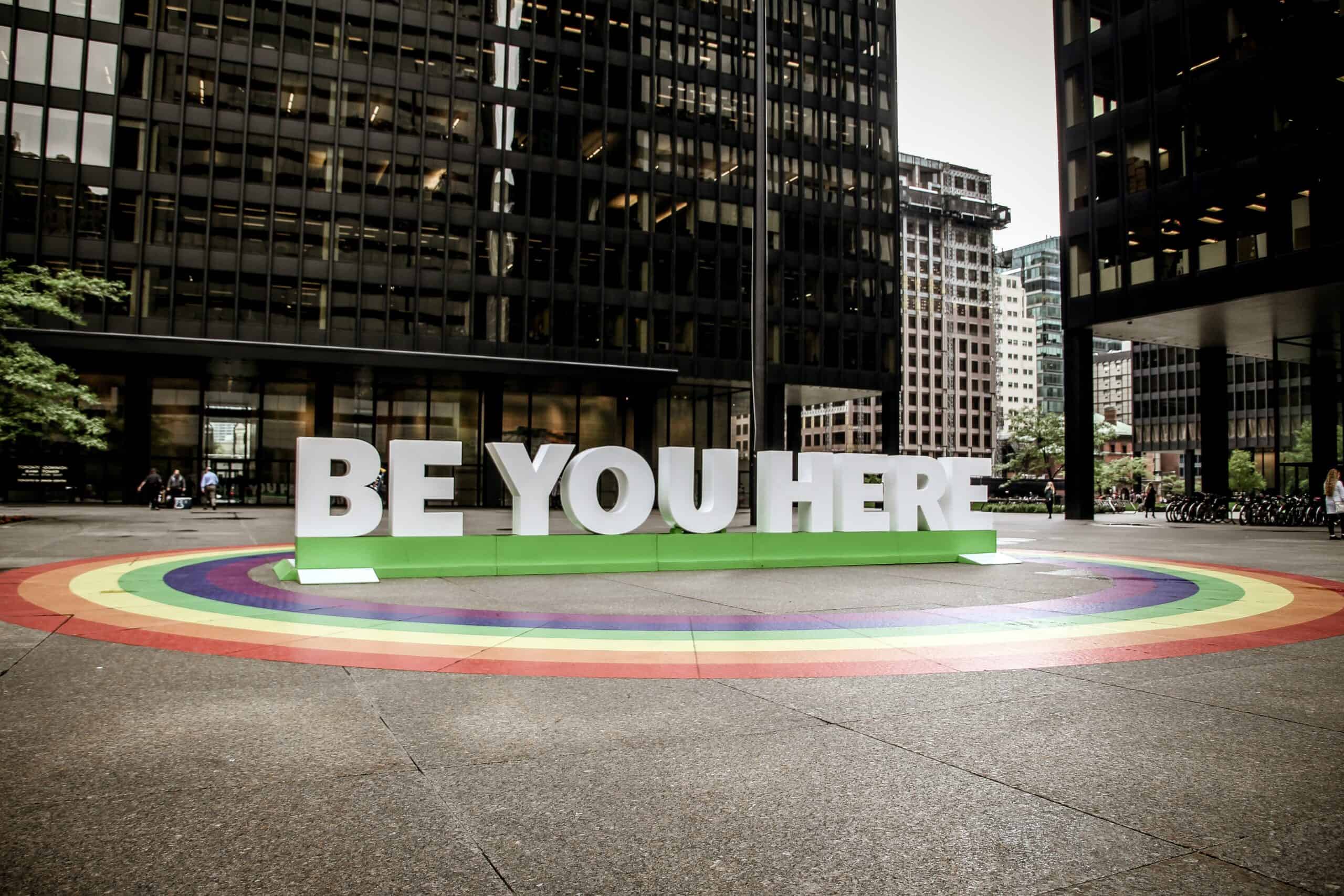 A statue in the middle of a square in Toronto, Canada that says "be you here"