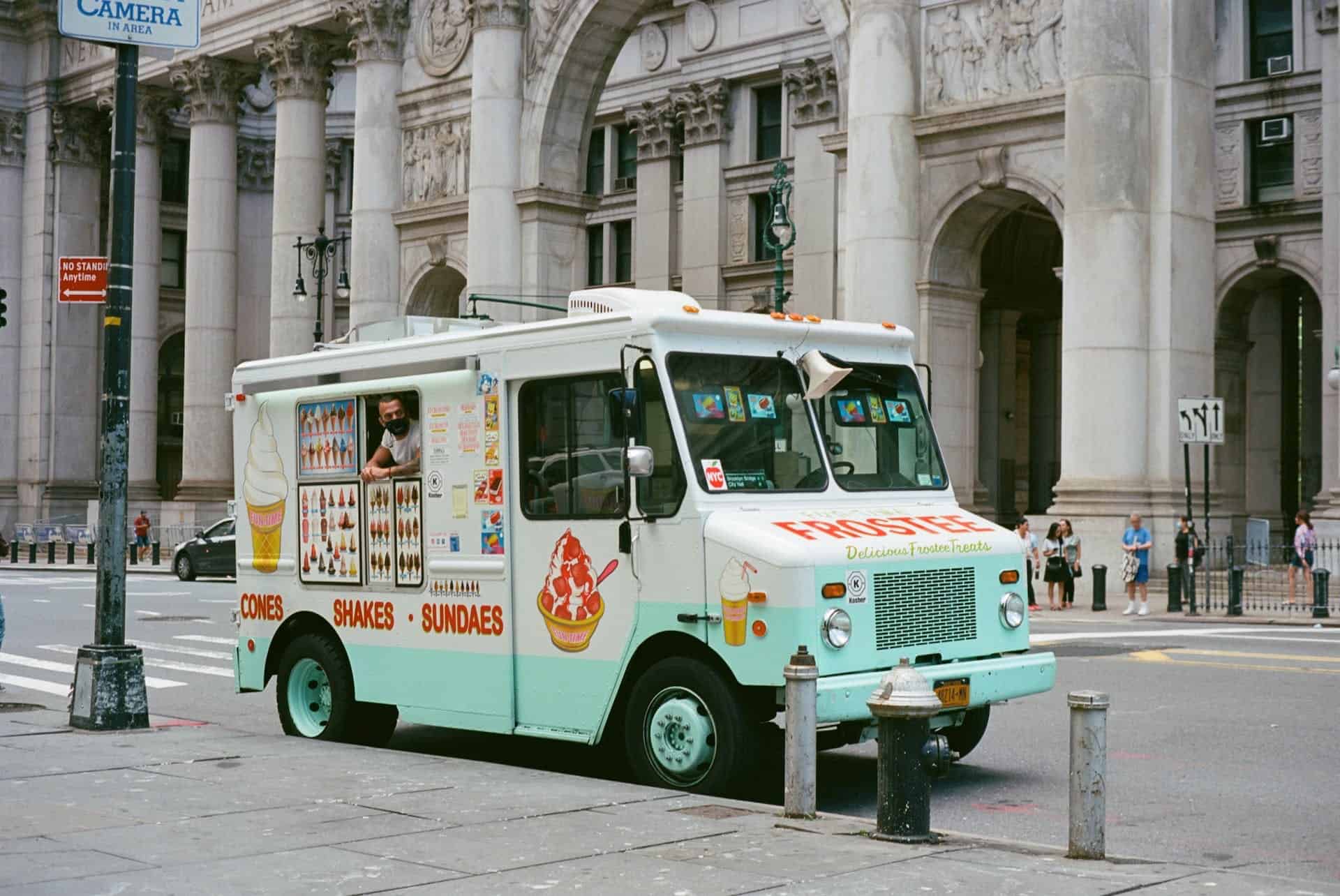 Ice cream truck parked outside a building in New York City. 