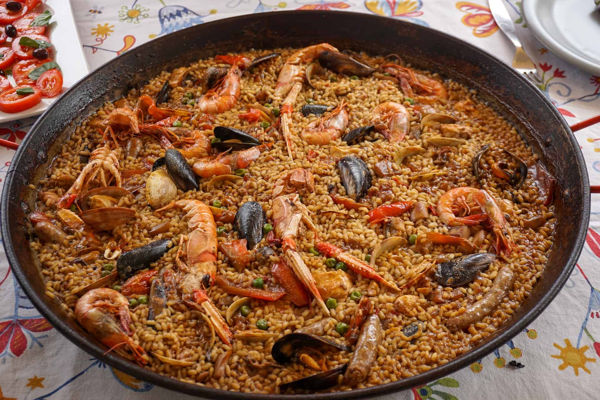 Large pan of paella sitting on a table.