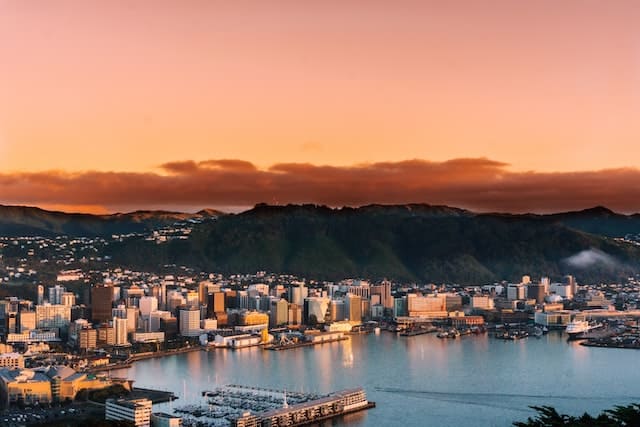Sunset over mountains and by the water in Wellington, New Zealand.