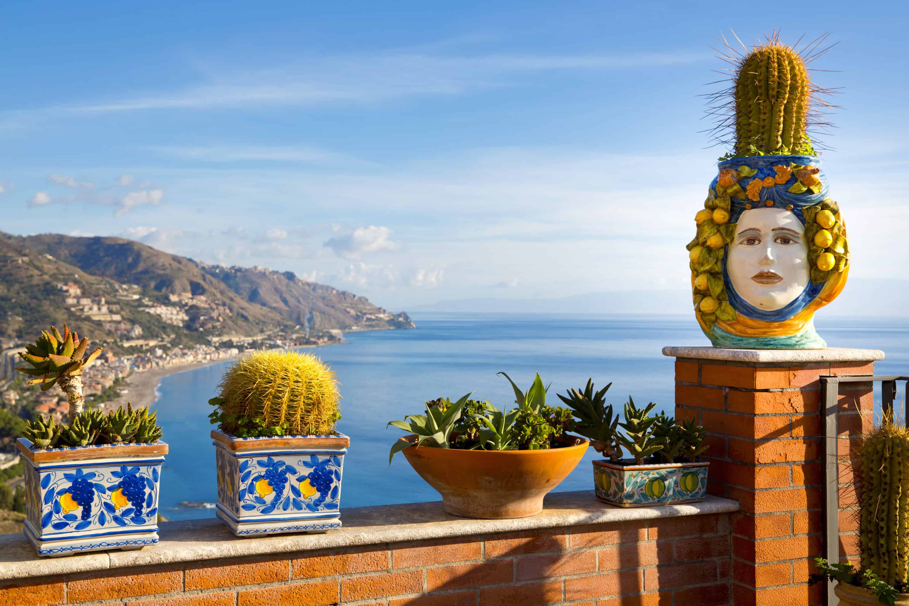 balcony with a face and designed planters looking over the sea in Taormina, Sicily