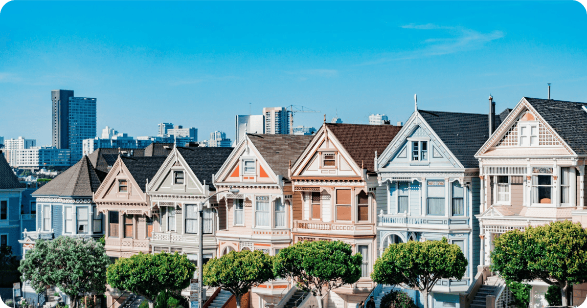 Painted Ladies houses in San Francisco with the city skyline in the background.